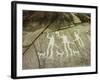 Petroglyph with three men brandishing axes, accompanied by dogs-Werner Forman-Framed Giclee Print