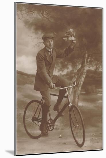 Photo of Man on Bicycle with Flowers-null-Mounted Art Print