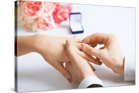 Picture of Man Putting Wedding Ring on Woman Hand-dolgachov-Stretched Canvas