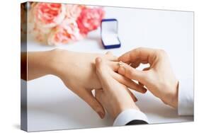 Picture of Man Putting Wedding Ring on Woman Hand-dolgachov-Stretched Canvas