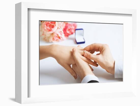 Picture of Man Putting Wedding Ring on Woman Hand-dolgachov-Framed Photographic Print