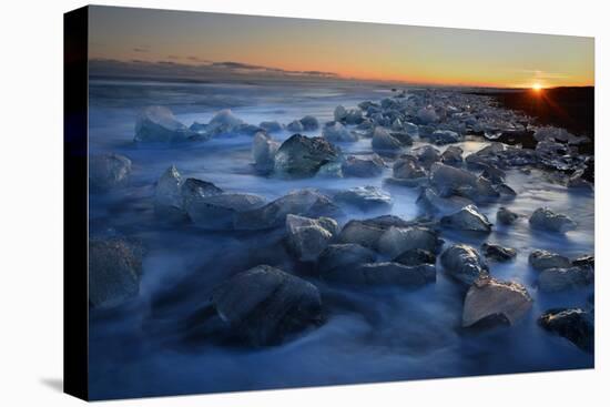 Pieces of glacial ice over black sand being washed by waves, Iceland-Raul Touzon-Stretched Canvas