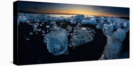 Pieces of glacial ice over black sand being washed by waves, Iceland-Raul Touzon-Stretched Canvas