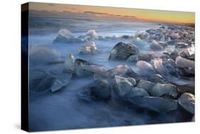 Pieces of glacial ice over black sand being washed by waves, Iceland-Raul Touzon-Stretched Canvas