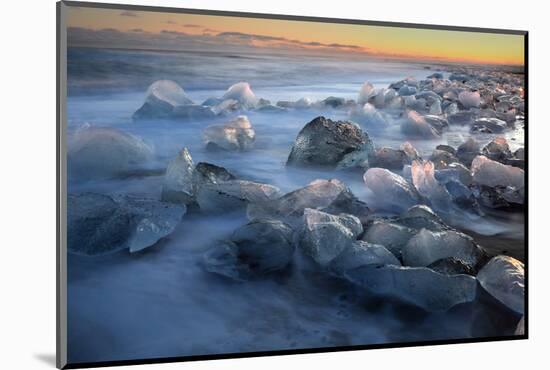 Pieces of glacial ice over black sand being washed by waves, Iceland-Raul Touzon-Mounted Photographic Print