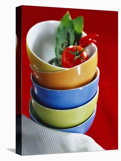 Pile of Soup Bowls with Tomato, Bay Leaf and Chilis-Karl Newedel-Stretched Canvas