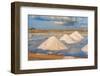 Piles of salts among salt flats with windmills in the background at sunset-Paolo Graziosi-Framed Photographic Print