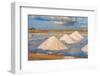 Piles of salts among salt flats with windmills in the background at sunset-Paolo Graziosi-Framed Photographic Print