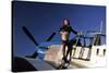 Pin-Up Girl Standing on the Wing of a P-51 Mustang-null-Stretched Canvas