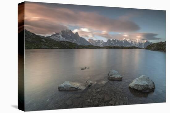 Pink clouds at sunrise on Mont Blanc massif seen from Lacs De Cheserys, Chamonix, Haute Savoie, Fre-Roberto Moiola-Stretched Canvas