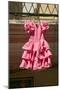 Pink flamenco dress for little girl hangs in Centro old district of Sevilla Spain-null-Mounted Photographic Print