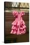 Pink flamenco dress for little girl hangs in Centro old district of Sevilla Spain-null-Stretched Canvas