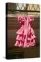Pink flamenco dress for little girl hangs in Centro old district of Sevilla Spain-null-Stretched Canvas