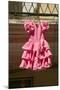 Pink flamenco dress for little girl hangs in Centro old district of Sevilla Spain-null-Mounted Photographic Print