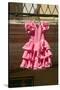 Pink flamenco dress for little girl hangs in Centro old district of Sevilla Spain-null-Stretched Canvas