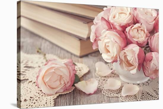 Pink Roses and Old Books on Wooden Desk-egal-Stretched Canvas