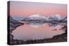 Pink sky at sunrise lights up the snowy peaks reflected in the cold sea, Bergsbotn, Senja, Norway-Roberto Moiola-Stretched Canvas