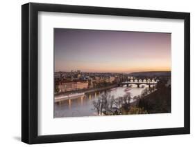 Pink sky on historical bridges and buildings reflected on Vltava River at sunset, Prague, Czech Rep-Roberto Moiola-Framed Photographic Print