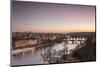 Pink sky on historical bridges and buildings reflected on Vltava River at sunset, Prague, Czech Rep-Roberto Moiola-Mounted Photographic Print