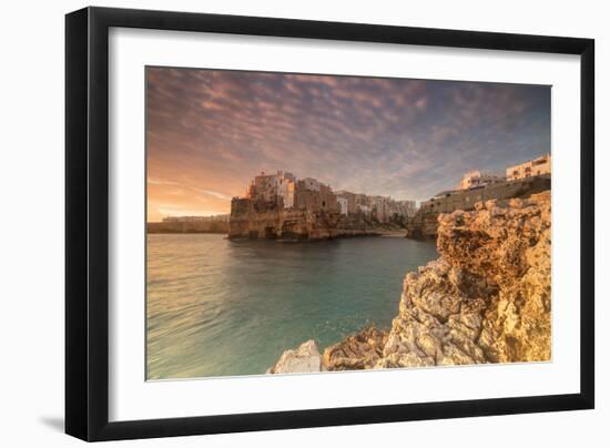 Pink sunrise on the turquoise sea framed by old town perched on the rocks, Polignano a Mare, Provin-Roberto Moiola-Framed Photographic Print