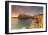 Pink sunrise on the turquoise sea framed by old town perched on the rocks, Polignano a Mare, Provin-Roberto Moiola-Framed Photographic Print