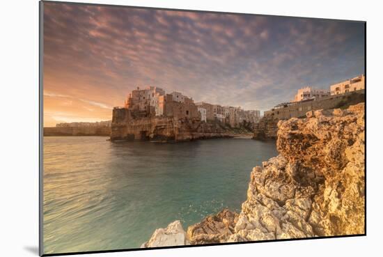 Pink sunrise on the turquoise sea framed by old town perched on the rocks, Polignano a Mare, Provin-Roberto Moiola-Mounted Photographic Print