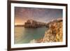 Pink sunrise on the turquoise sea framed by old town perched on the rocks, Polignano a Mare, Provin-Roberto Moiola-Framed Photographic Print