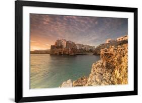 Pink sunrise on the turquoise sea framed by old town perched on the rocks, Polignano a Mare, Provin-Roberto Moiola-Framed Photographic Print