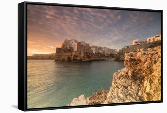 Pink sunrise on the turquoise sea framed by old town perched on the rocks, Polignano a Mare, Provin-Roberto Moiola-Framed Stretched Canvas