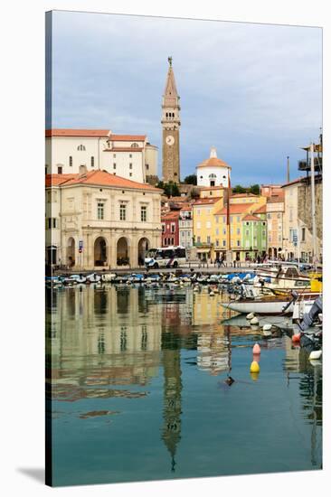 Piran, Primorska, Slovenia. View across harbour to Tartinijev trg (or square) and the spire of S...-null-Stretched Canvas