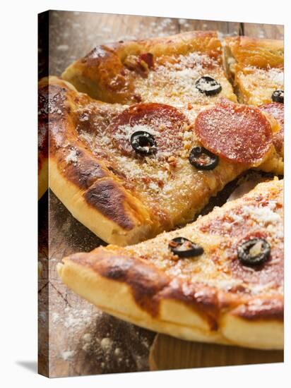 Pizza with Salami, Cheese and Olives, Pieces Cut-null-Stretched Canvas