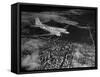 Plane Flying over a City from a Story Concerning United Airlines-Carl Mydans-Framed Stretched Canvas