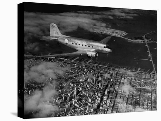 Plane Flying over a City from a Story Concerning United Airlines-Carl Mydans-Stretched Canvas