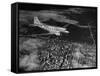 Plane Flying over a City from a Story Concerning United Airlines-Carl Mydans-Framed Stretched Canvas