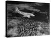 Plane Flying over a City from a Story Concerning United Airlines-Carl Mydans-Stretched Canvas