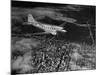 Plane Flying over a City from a Story Concerning United Airlines-Carl Mydans-Mounted Photographic Print