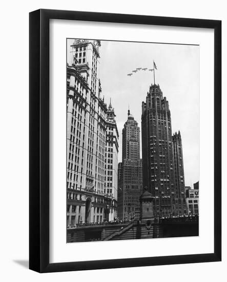 Planes Fly over Buildings in Chicago-null-Framed Photographic Print