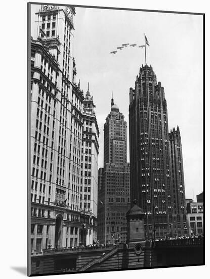 Planes Fly over Buildings in Chicago-null-Mounted Photographic Print