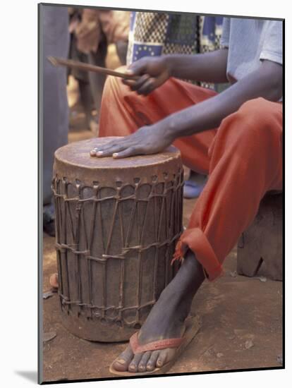 Playing a Congolese Drum in a Congolese Refugee Camp, Tanzania-Kristin Mosher-Mounted Photographic Print