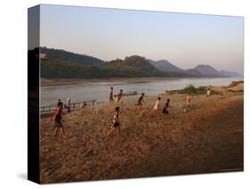 Playing Football on the Banks of the Mekong River, Luang Prabang, Laos, Indochina-Andrew Mcconnell-Stretched Canvas