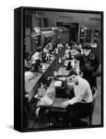 Playwright Paddy Chayefsky Sitting at Typewriter in Garment Factory With Workers on Sewing Machines-Michael Rougier-Framed Stretched Canvas