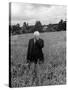 Poet Robert Frost Standing in Oxford Field with His Hand over His Face-Howard Sochurek-Stretched Canvas
