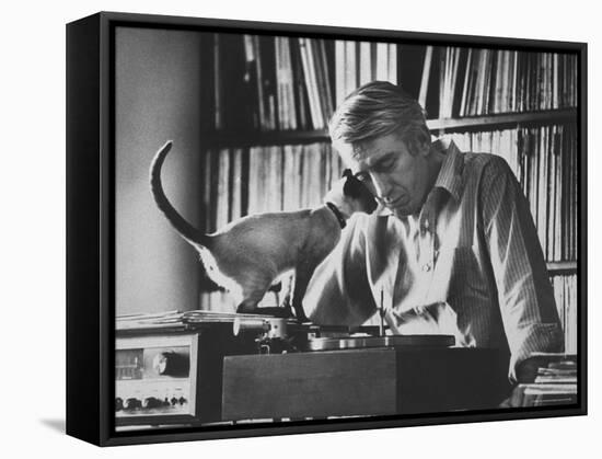 Poet Rod McKuen Playing Record on Stereo Set While Pet Siamese Cat Nuzzles His Face Affectionately-Ralph Crane-Framed Stretched Canvas