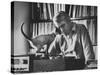 Poet Rod McKuen Playing Record on Stereo Set While Pet Siamese Cat Nuzzles His Face Affectionately-Ralph Crane-Stretched Canvas