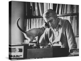 Poet Rod McKuen Playing Record on Stereo Set While Pet Siamese Cat Nuzzles His Face Affectionately-Ralph Crane-Stretched Canvas