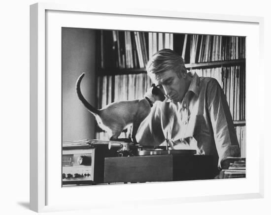 Poet Rod McKuen Playing Record on Stereo Set While Pet Siamese Cat Nuzzles His Face Affectionately-Ralph Crane-Framed Premium Photographic Print