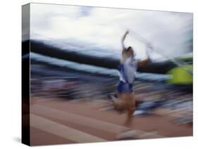 Pole Vaulter Flys over the Bar-Steven Sutton-Stretched Canvas