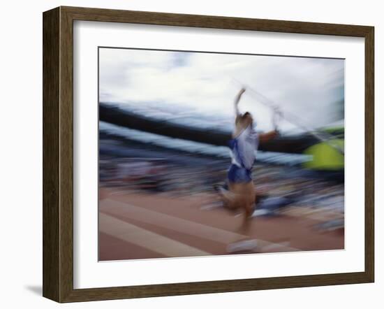 Pole Vaulter Flys over the Bar-Steven Sutton-Framed Photographic Print