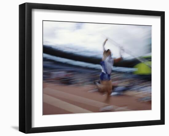 Pole Vaulter Flys over the Bar-Steven Sutton-Framed Photographic Print