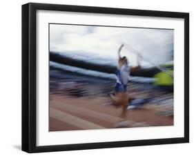 Pole Vaulter Flys over the Bar-Steven Sutton-Framed Photographic Print